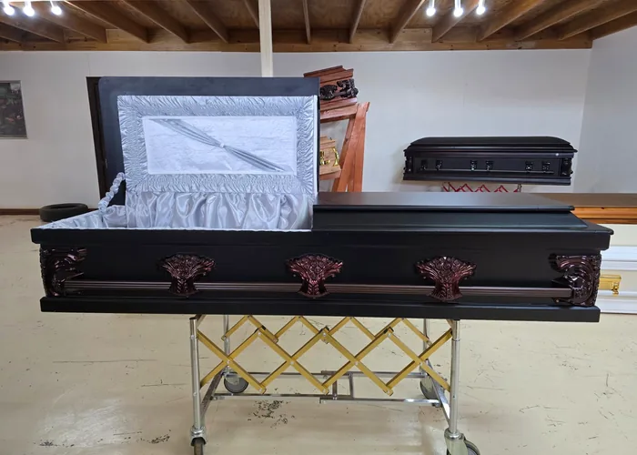 A coffin with a lined interior prepared for a service