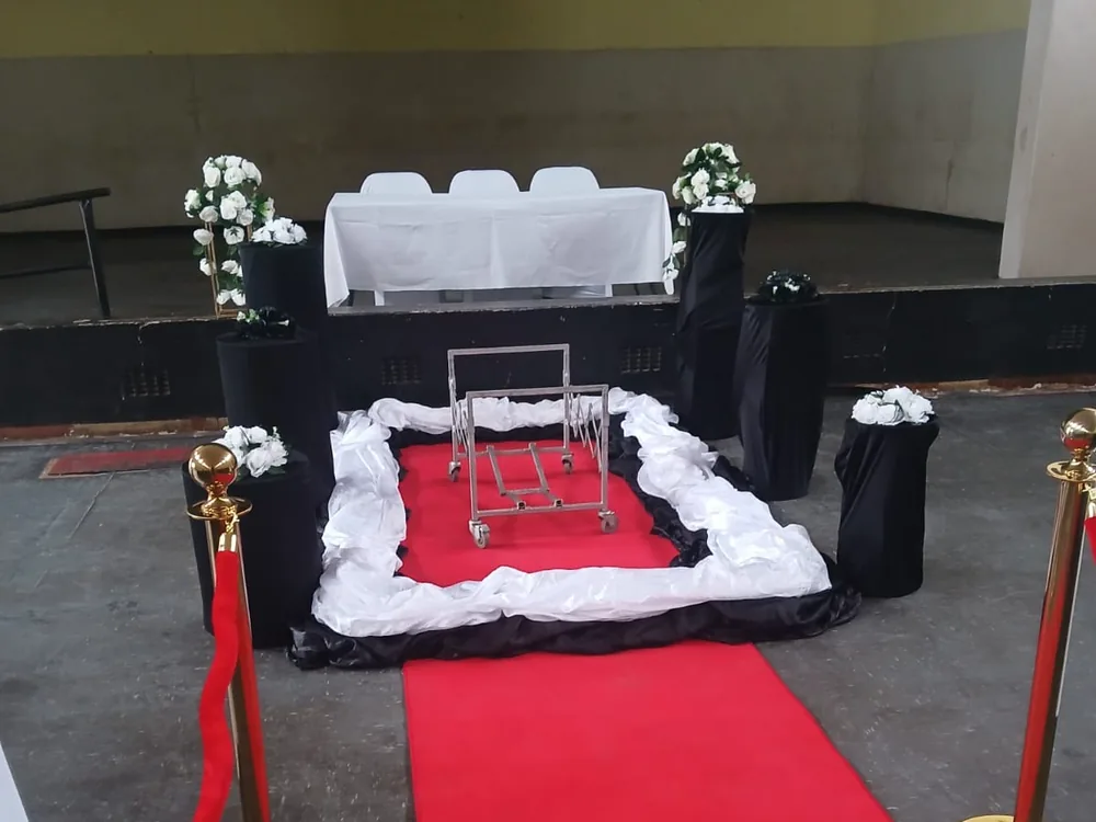 A chapel prepared by Bambanani with red carpet and floral arrangements