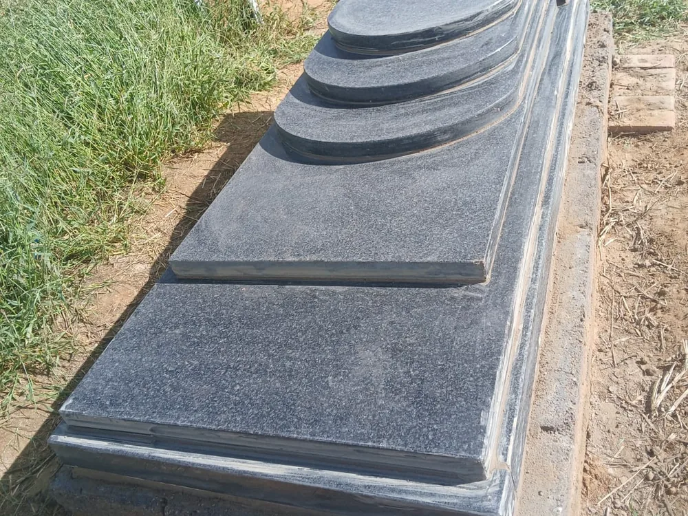 A finished granite memorial installed by Bambanani